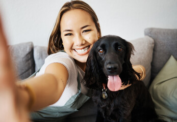 Wall Mural - Selfie, love and woman with dog on home sofa to relax and play with animal. Pet owner, care and asian person influencer with companion, smile and friendship or social media profile picture and memory