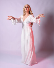 Wall Mural - Full length portrait  of blonde woman  wearing white historical bridal gown fantasy costume dress.    Standing pose, facing forwards with gestural arms reaching out , isolated on studio background.