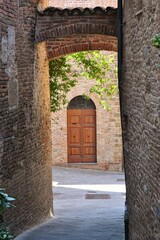 Canvas Print - A street between the houses of Città della Pieve, a medieval village in Umbria, Italy.