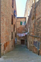 Canvas Print - A street between the houses of Città della Pieve, a medieval village in Umbria, Italy.