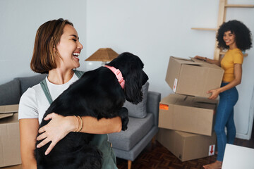 Poster - Dog, lesbian couple and new real estate, funny and bonding together in living room. Happy gay women with pet in house, apartment and moving in to property home, laughing and playing with animal