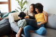 © aLListar/peopleimages.com - Dog, laptop or gay couple hug on sofa to relax together in healthy relationship love connection. Lgbtq, home or happy lesbian women with a pet animal to bond on living room couch for remote work