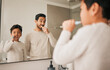 © Talia Mdlungu/peopleimages.com - Dad, boy and child brushing teeth in mirror for hygiene, morning routine and teaching healthy oral habits at home. Father, kid and dental cleaning in bathroom with toothbrush, fresh breath and care