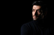 © Nutlegal - Pensive thinking handsome young beared man portrait Attractive bearded confident guy planning something looking at blank space Smart man thinking in the dark room Cool man look smart and good looking