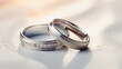 couple of silver plain style wedding rings on white and some decoration background, top view, classic