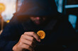 a man holding golden coins with bitcoin symbol