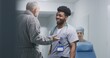 © Framestock - African American doctor consults old patient about his health in clinic corridor. Senior man talks with professional medic. Nurse transports wheelchair down the hospital hallway to medical room.