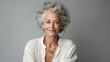 Senior model with grey hair laughs and smiles. Portrait of an elderly lady in close-up. Skincare cosmetics, healthy face skin care.