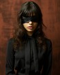 © Vagner Castro - An intriguing portrait of a woman blindfolded by a velvet noir style fabric. Woman with blindfold and beautiful curves of her lips in an aura of suspense.