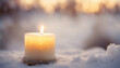 Beautiful christmas candle in the winter snow with copy space
