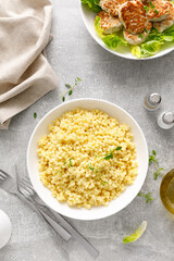 Canvas Print - Couscous with chicken patties, cutlets with fresh romaine lettuce salad, top down view