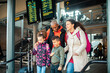 © Marko Geber - Young mixed family waiting for their train at the train station