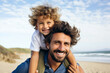 © Impressionstock - Dad and son. A Dad Carries His Son on His Shoulders, Exploring the Beach Together.