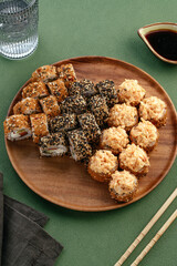 Wall Mural - Sushi and soy sauce in a bowl and wooden chopsticks on a gray wooden table. Japanese food. 