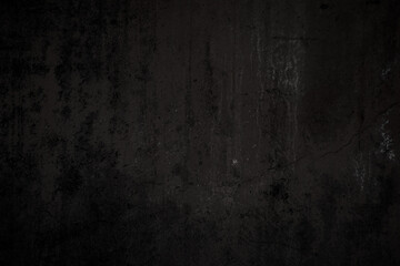 Wall Mural - Front view of a dirty, worn and weathered dark gray concrete wall with paint partly faded. Abstract full frame textured background in black and white with copy space.