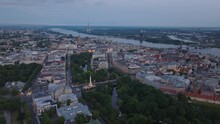 Aerial Slide And Pan Footage Of Latvian National Opera Surrounded By Park And Buildings In City Centre. Panoramic View City At Dusk. Riga, Latvia