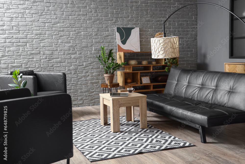 Interior of modern living room with black couch and table