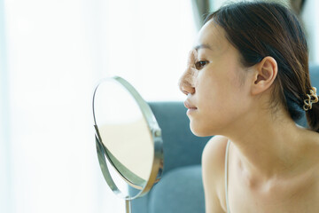 Close up of happy Asian beautiful woman portrait during her face and nose covered by soft splint after have a beauty plastic surgery