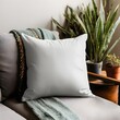 © Mockup Lab - Blank plain white square throw Pillow Mockup on sofa in living room Background, Product photography, potted plants, minimalistic