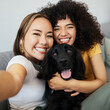 © aLListar/peopleimages.com - Dog, portrait or lesbian couple in selfie in home to relax together on social media for profile picture or memory. Lgbtq, pet animal or happy women smile in photo with bond or care in living room