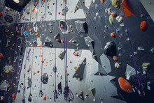 Artificial Climbing Wall With Colorful Grips And Ropes