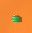 © Cavan Images - Christmas macaroon bauble on orange background