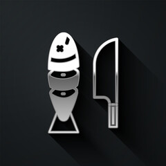 Sticker - Silver Fish with sliced pieces with knife icon isolated on black background. Long shadow style. Vector