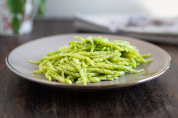 Trofie with pesto sauce, typical italian food from Liguria. Mediterranean dish suitable for those following a vegetarian diet.