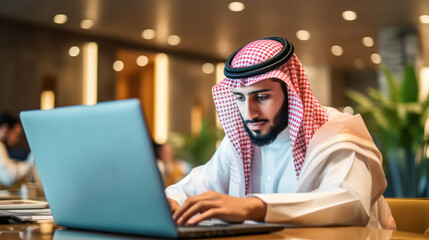 Portrait of arabic businessman using laptop computer in office.