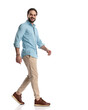 © Viorel Sima - happy casual man in denim shirt with chino pants and sneakers walking