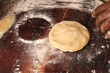 Making and preparing chapati and roti bread, Piece of dough made up of flour ready to be pressed and make roti or flat bread. Making roti for breakfast. Dough on a  table ready to be cooked.