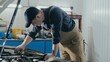 © Alexander - An auto mechanic inspects a car for damage. A mechanic diagnoses a car engine. Old car repair