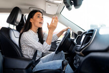 Woman Driver Stuck In Traffic Jam Gesturing With Hand, Screaming