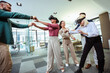 © Mediteraneo - Group of professional people playing with VR glasses on the work in the modern office.Team Building