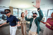 © Mediteraneo - Group of professional people playing with VR glasses on the work in the modern office.Team Building