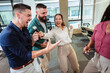 © Mediteraneo - Group of professional people singing karaoke in the modern office