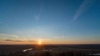 Wall Mural - Sunset timelapse above the valley, view from the mountain. Blue sky with moving clouds. Beautiful landscape, 4k