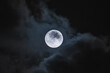 © ADDICTIVE STOCK - Amazing scenery of white glowing moon with craters in black sky with clouds at night