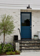Dark blue Dutch door to a modern brick building
