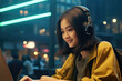 © vefimov - Woman sitting in front of laptop wearing headphones. This image can be used to represent online communication, remote work, or listening to music while working.