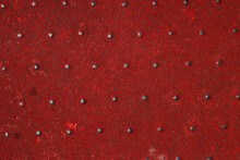 Grunge Steel Industrial Boat Floor Plate Painted Dark Vivid Red Anti-rust Paint. Robust Ferry Ship Metal Pattern. Old Dotted Iron Deck. Worn Metal Texture Background. Modern Design Concept. Copy Space