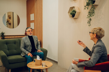 Wall Mural - An anxious man is having a session with a psychotherapist