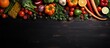 Abundant fresh produce and spices on a black wooden background Space for text Overhead perspective with copyspace for text