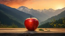 Apple On A Table In Front Of A Mountain At Sunset