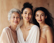 © Glittering Humanity - Beauty and unity, this diverse group of beautiful women of all skin tones and races together posing in the skin care ad campaign. A multiracial diverse group of women, inclusivity body positivity.