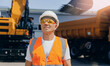 Man driver builder operate crane or excavator at construction site. Industry worker portrait