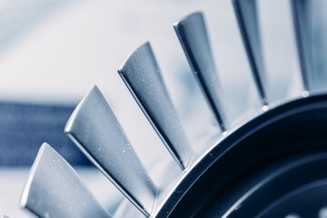 Macro steel blades of turbine propeller blue color with sunlight