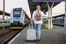 Woman Traveling By Train. Tourist With Suitcase In Hurry At Railroad Station Platform. Travel Lifestyle