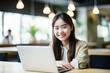 © CYBERUSS - Portrait of Happy Asian Female Student Learning Online in Coffee Shop, Young Woman Studies with Laptop in Cafe, Doing Homework