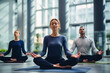 Employees take a break from work to practice yoga, enhancing their well-being and focus in an open space office environment